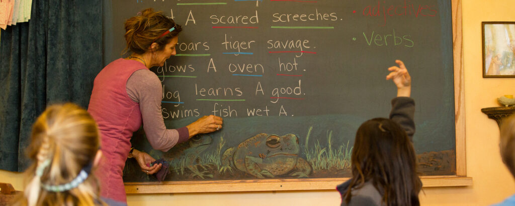 Teacher Anji at the chalkboard